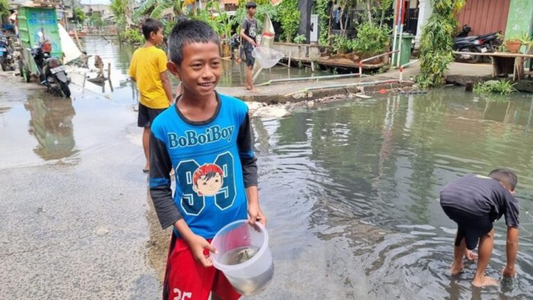 Banjir Pegangsaan Dua: Anak-anak Tangkap Ikan Mujaer untuk Lauk Gorengan Banjir Pegangsaan Dua: Anak-anak Tangkap Ikan Mujaer untuk Lauk Gorengan